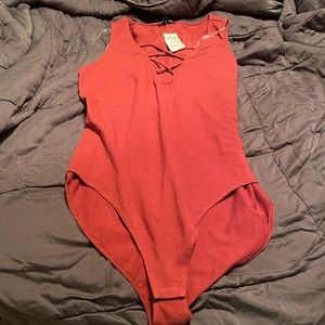 One piece sleeveless body suit.